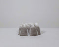 Pre-filled worm fertiliser tea bags stacked